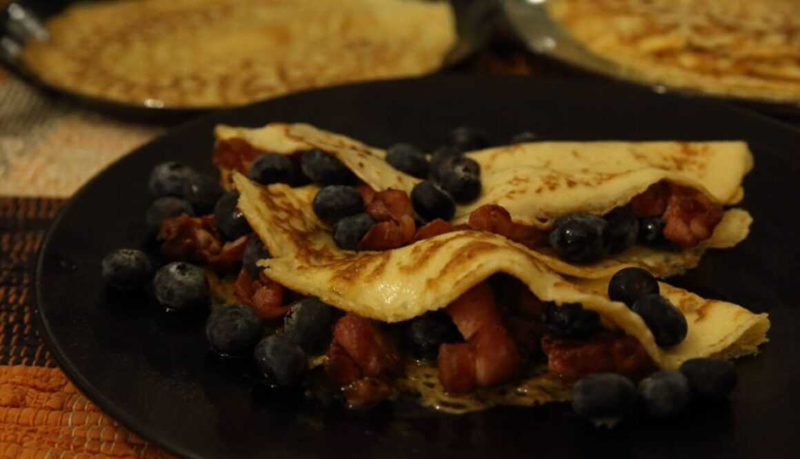 French crepes with bacon, maple syrup and blueberries