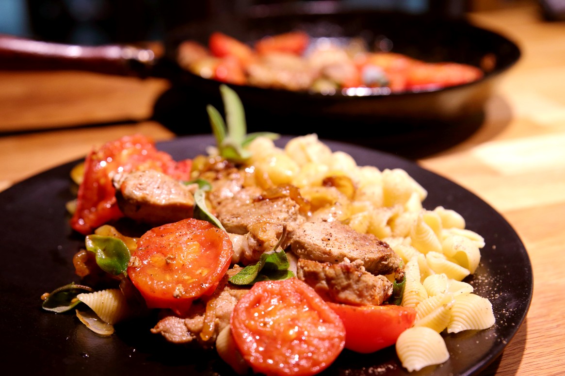 Pork tenderloin with onions, fried tomatoes, and sage