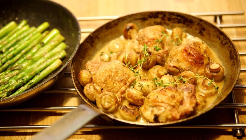 Roasted chicken with mushrooms in a white wine sauce with mint asparagus