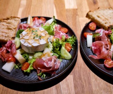 Camembert cheese salad with melon and Parma ham
